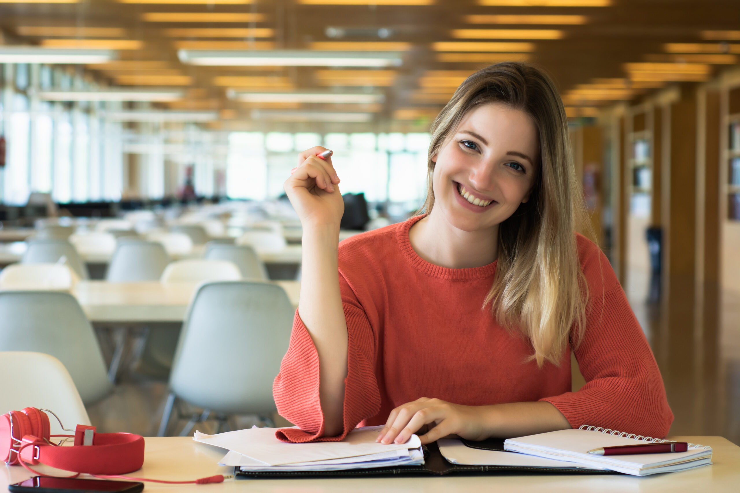 Young female student studying in the library.